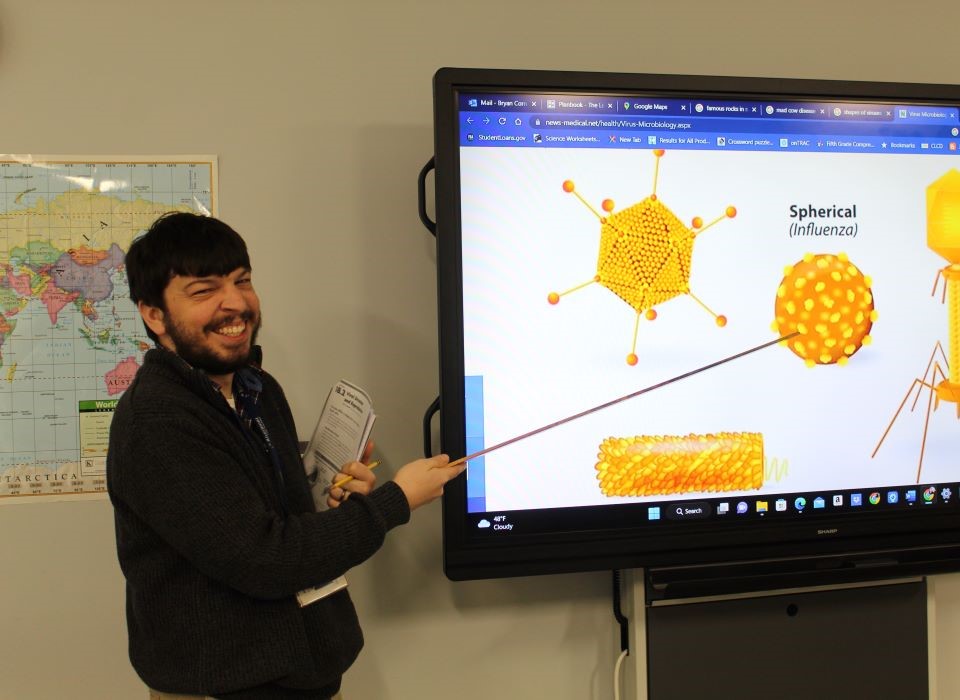 Teacher pointing at smartboard during lesson