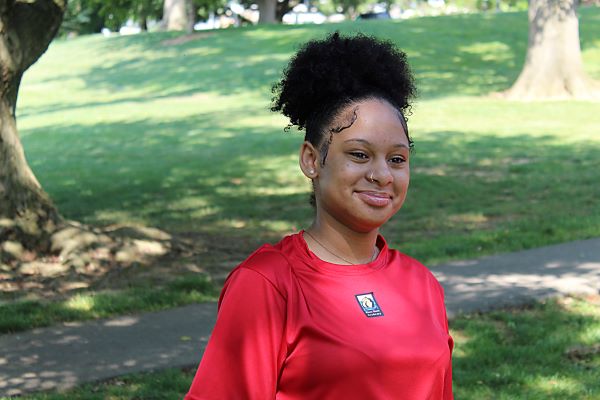 Student smiling in park