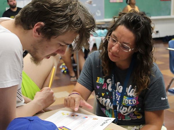 Student and teacher working together on desk work