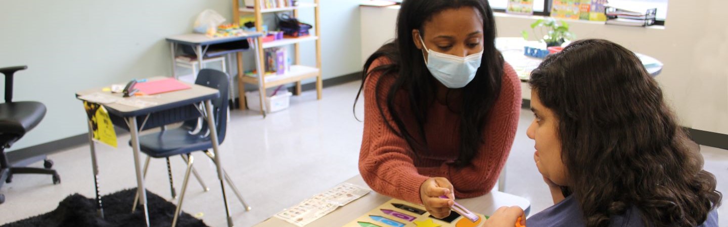 Teacher and student working on a puzzle