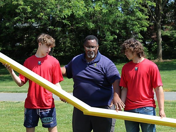 Teacher giving students instruction on field day activity