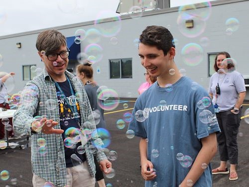 Student and teacher playing with bubbles