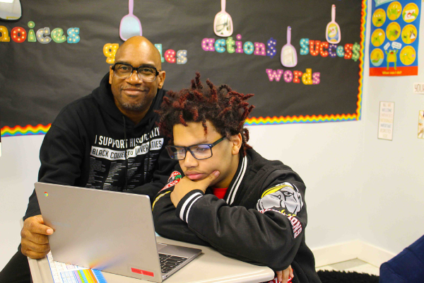 Teacher smiling with student
