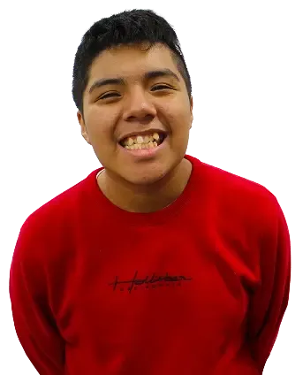 Smiling student wearing a red sweatshirt, standing and facing the camera